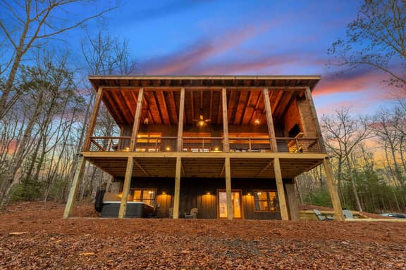 Enjoy the great outdoors on two expansive decks with outdoor furniture, grill, tv, fireplace, fire pit, and hot tub!